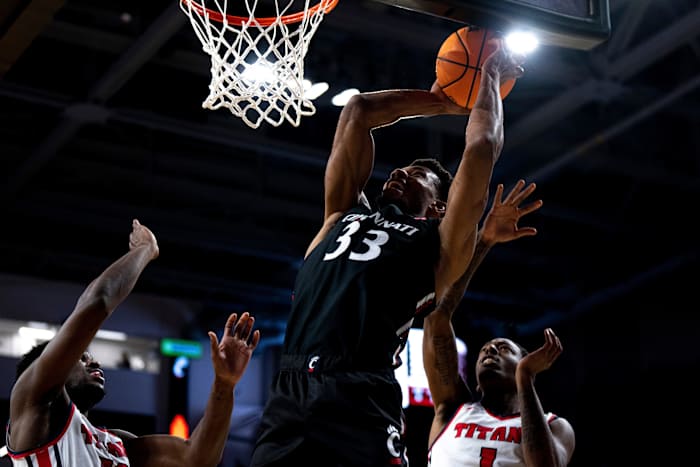 Cincinnati Bearcats forward Ody Oguama (33) hits a shot over Detroit Mercy Titans forward Jordan Phillips (12) and Detroit Mercy Titans guard T.J. Moss (1) in the first half of the NCAA men s basketball game at Fifth Third Arena in Cincinnati on Wednesday, Dec. 21, 2022. Ncaa Basketball Detroit Mercy Titans At Cincinnati Bearcats